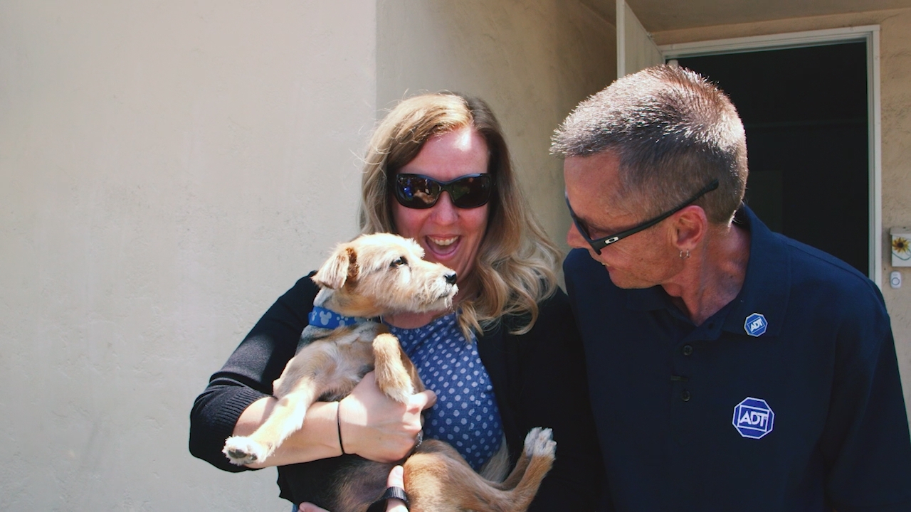 Amber Cooper of Anaheim holds Fiona, a Yorkshire Terrier mix rescue dog, that was rescued from a house fire by Anaheim Fire & Rescue with the help of ADT dispatcher Dave Tompkins.